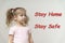 Stay home and stay safe save life text on dark background and little girl