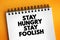 Stay Hungry Stay Foolish text on notepad, concept background