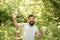 Stay Hydrated. hot summer day. feel thirsty. bearded man look happy. brunette bearded man with water bottle in forest