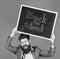 Stay positive. Teacher bearded man holds blackboard with inscription back to school blue background. Teacher with