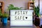 Stay safe sign written in lightbox