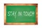 STAY  IN  TOUCH text written on green school board