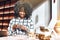 Always stay in touch! A young beautiful african american is sitting in a cafe and using a telephone