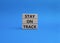 Stay on track symbol. Wooden blocks with words Stay on track. Beautiful blue background. Business and Stay on track concept