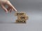 Stay on track symbol. Wooden blocks with words Stay on track. Beautiful grey background. Businessman hand. Business and Stay