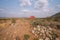 Stay on Trail poster  in the middle of desert on unpaved road