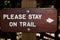 Stay on the trail sign