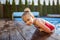 Staycation in summer cottage. Kid cooling off in the swimming pool, happy summertime