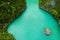 Staying afloat is what I do best. High angle shot of a man swimming in a canal running along the Raja Ampat Islands in