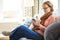 Staying connected and up to date during her retirement. a mature woman using a phone at home on the sofa.