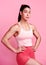 Staying dedicated and disciplined. Studio portrait of a sporty young woman posing with her hands on her hips against a