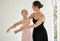 Staying engaged, motivated and inspired. a young girl practicing ballet with her teacher in a dance studio.