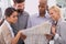 Staying one step ahead of the competition. a group of work colleagues reading a newspaper.