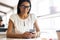 Staying in touch. Young businesswoman in formalwear holding mobile phone while sitting at her working place