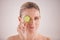 Staying youthful the natural way. Cropped studio portrait of a beautiful mature woman posing with a slice of cucumber.