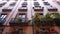 Steadicam shot: house exterior with balconies in Madrid. Facades of medieval apartment buildings in narrow street of