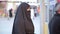 Steadycam - Woman with headscarf, chador using ATM machine, istanbul