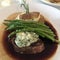 Steak with blue cheese topping asparagus and baked potato dinner.