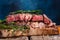 Steak cooked in Rare, marbled beef. With rosemary on a kitchen wood background. Cooking meat, cooking recipes, recipe book