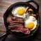 steak and eggs in a cast iron pan .rustic style