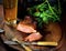 Steak with herbs, hot peppers, cold frothy beer in a glass, vintage knife and fork on a wooden background