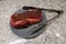 A steak marinating on a blue plate on the counter of a home