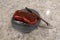 A steak marinating on a blue plate on the counter of a home