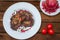 Ð Steak on ribs, cooked on a grill with pomegranate on a white plate. Wooden rustic background. Top view