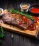 Steak with spicy sauce and spices. Juicy marble meat, grilled, beautifully laid out on wooden board. Close-up