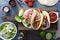 Steak tacos with sliced meet, salad and tomato salsa