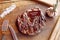 Steak on a wooden board, medium well knife, fork