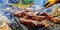 Steaks on the grill with yellow gloves and tong camping grilling barbeque