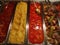 Steaks, polenta and sauces in stainless steel trays