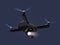 Stealth drone equip with search light flying in the night sky