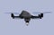 Stealth drone equip with search light flying in the sky