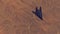 Stealth Fighter Jet Aircraft High Altitude Above Arid Mountain Desert with Sediment Mudflat