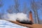 Steam billowing from a maple syrup sugar shack