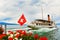 Steam boat with swiss flag floating on the lake