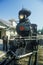 A steam engine conductor as he stands near the cowcatcher on the front, Eureka Springs, Arkansas