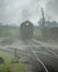 Steam Engine Locomotive with Passenger cars Arriving into Station