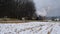 Steam Engine and Passenger Cars Puffing Along Amish Farm Lands After the First Snow