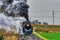 Steam Freight Train Blowing Black Smoke and Steam