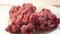 Steam from frozen raspberries. Frozen fresh berries. Frozen berries of raspberries, covered with hoarfrost. Close-up