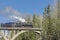 Steam locomotive driving over the bridge