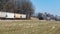 Steam Locomotive and Freight Hopper Cars in Amish Countryside