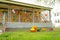 Steam locomotive made of plastic boxes and bottles on lawn next to terrace on playground