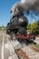 Steam locomotive stops on the tracks, in the countryside