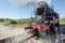 Steam locomotive stops on the tracks, in the countryside