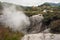 steam raising from craters in Waiotapu