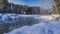 Steam rises above the ice-free river.